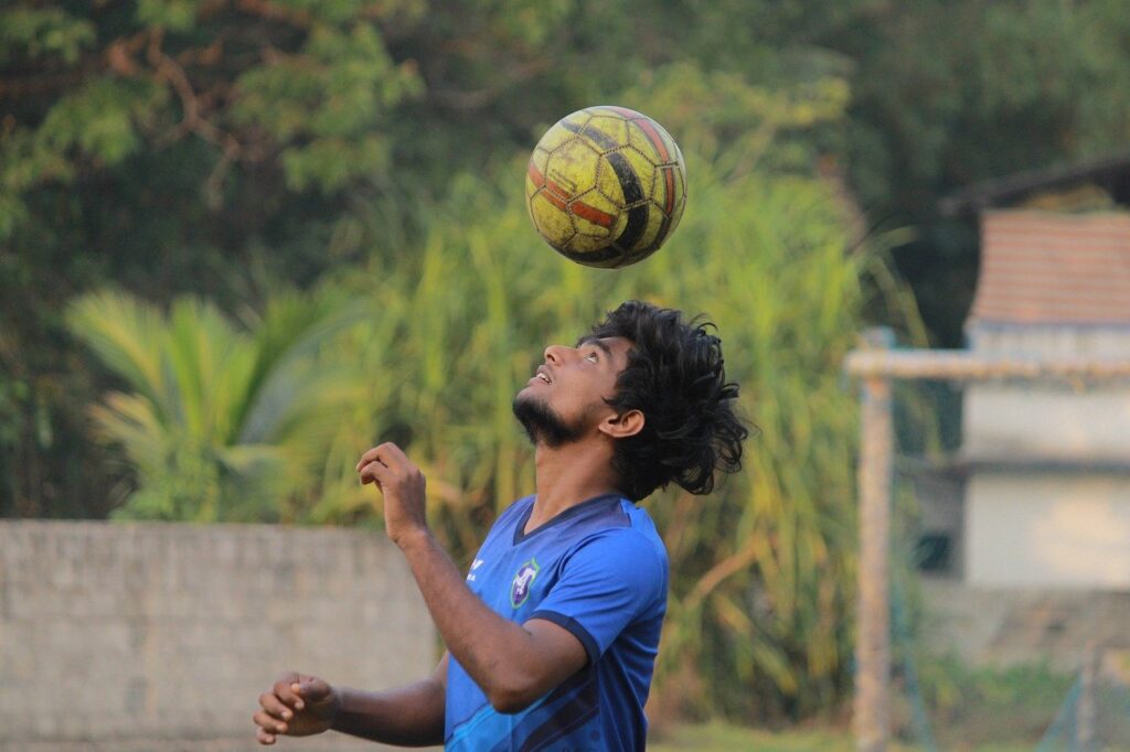 Boy playing football on head