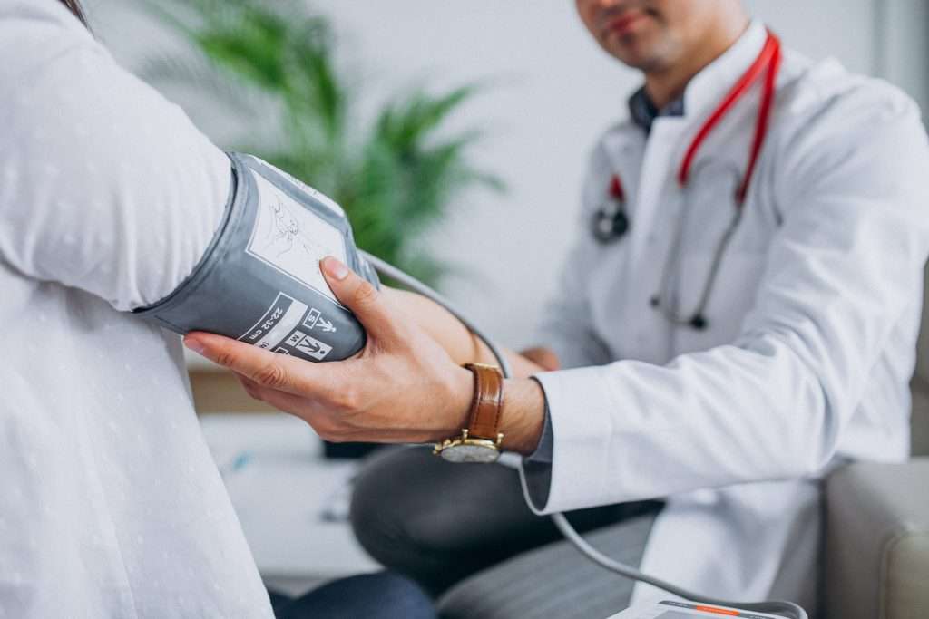 Doctor checking pressure of a patient