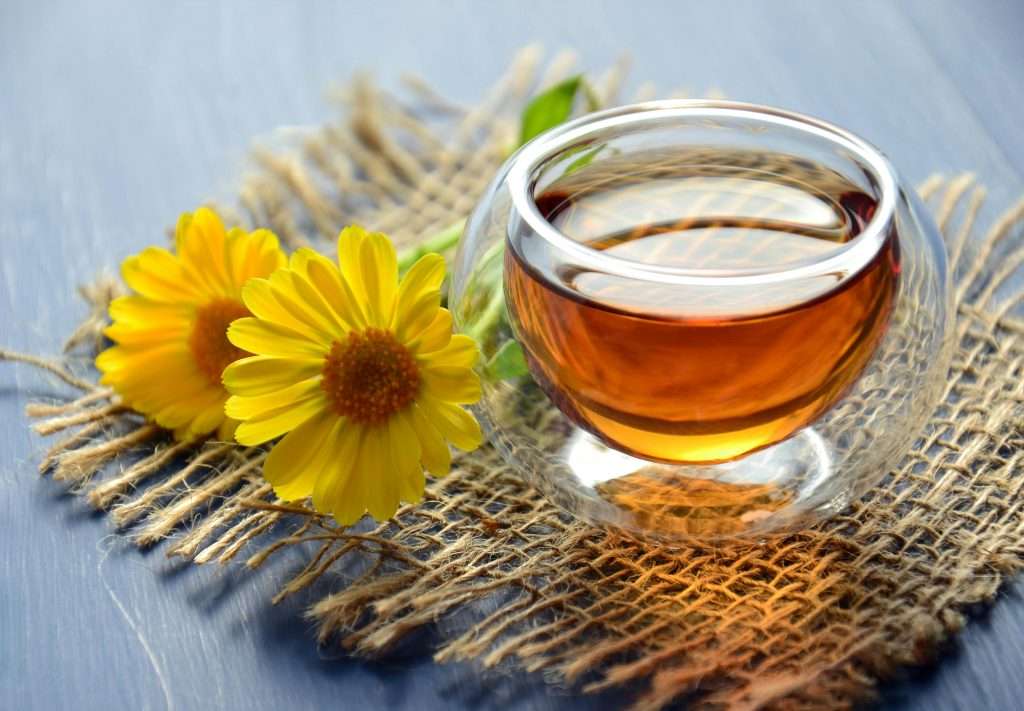 Tea cup with flower beside