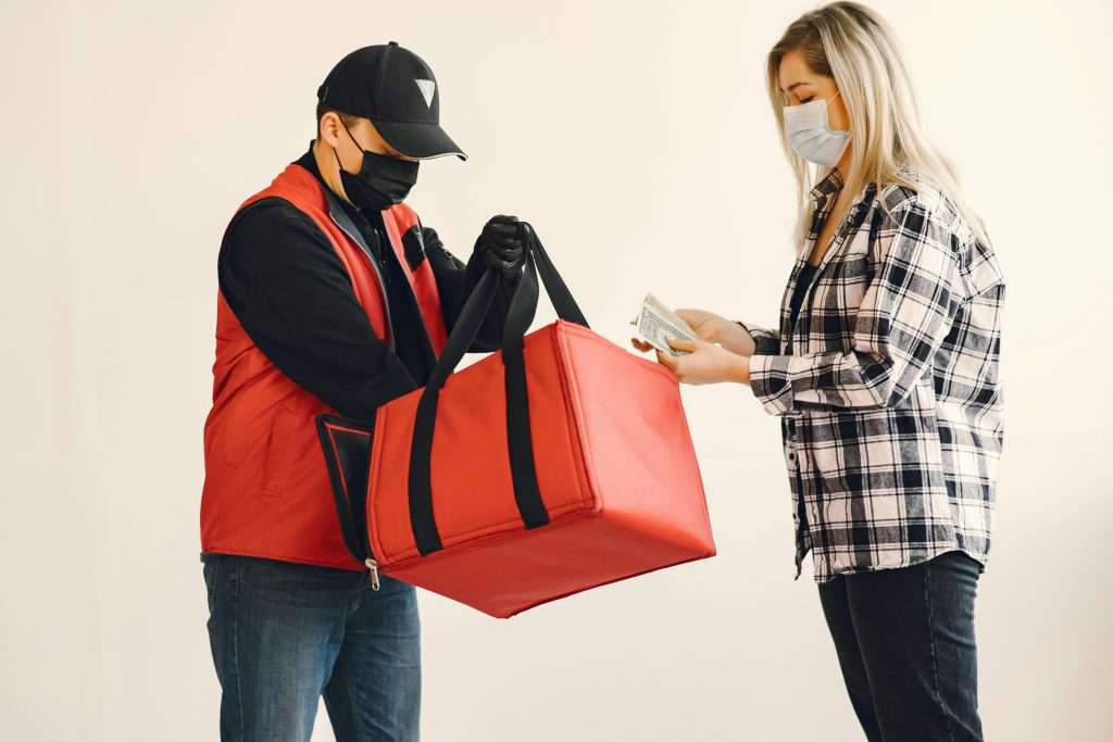 Man handing over the food to another person