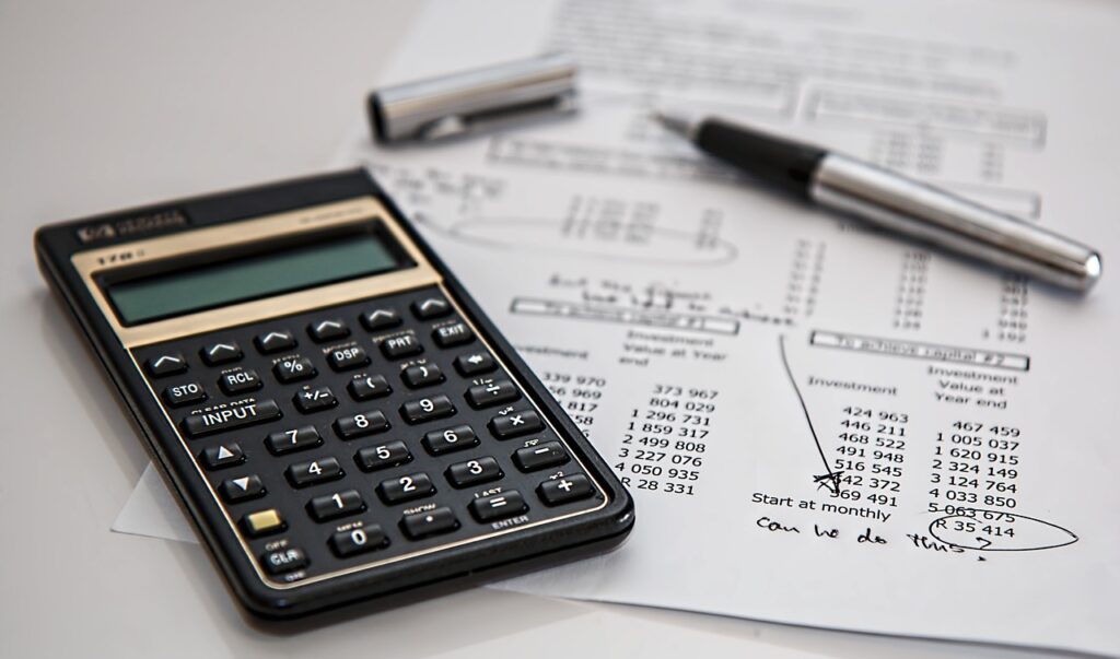 Paper and pen laying below the calculator