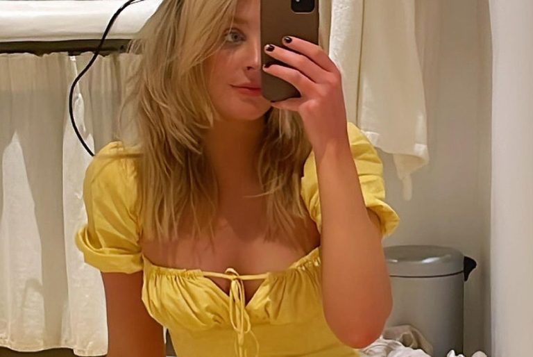 Ava Evans taking selfie in yellow dress