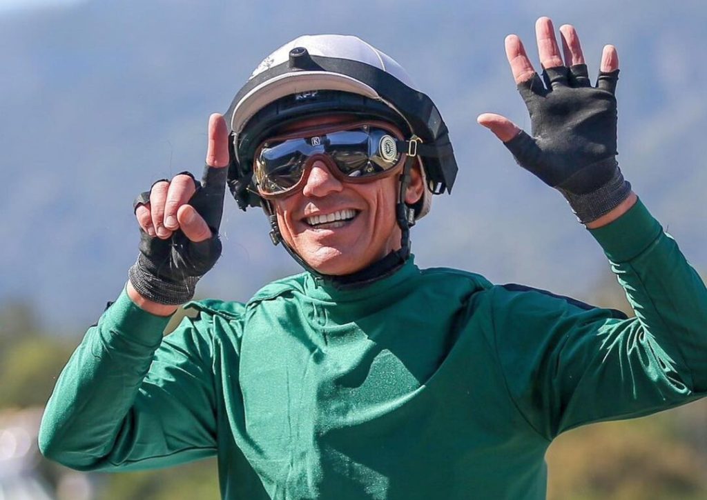 Frankie Dettori in jockey gears celebrating.