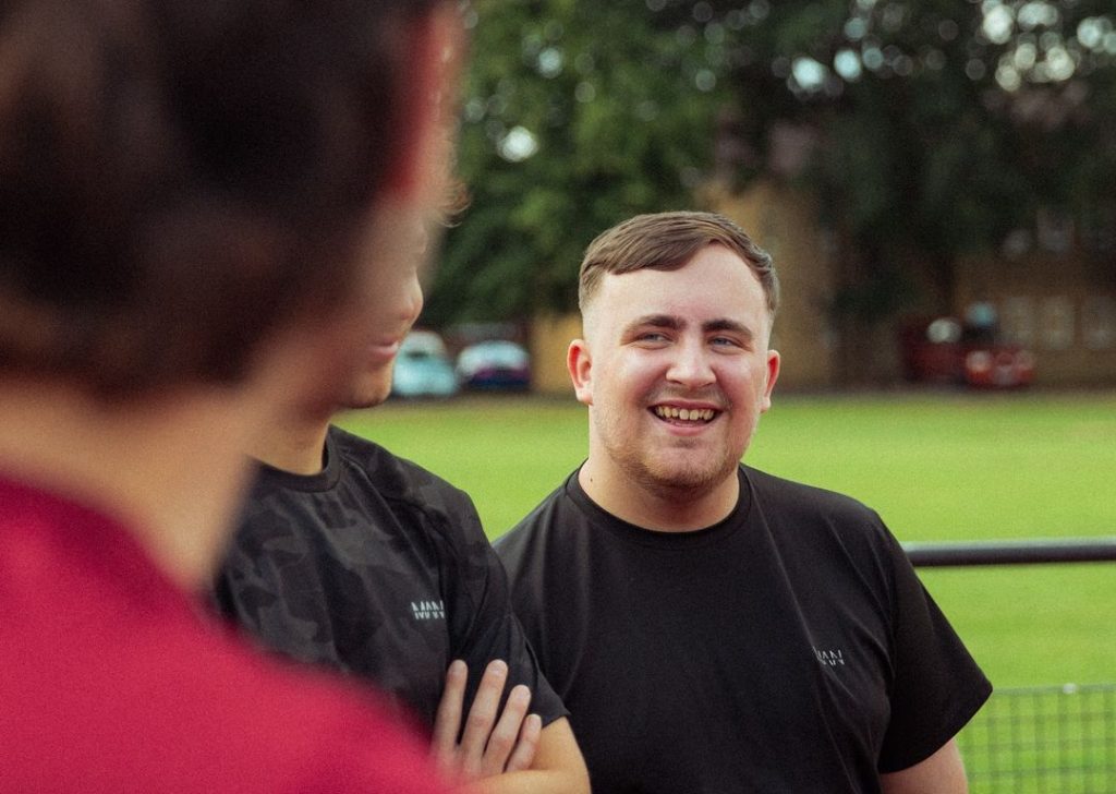 LUKE LITTLER smiling in black tshirt