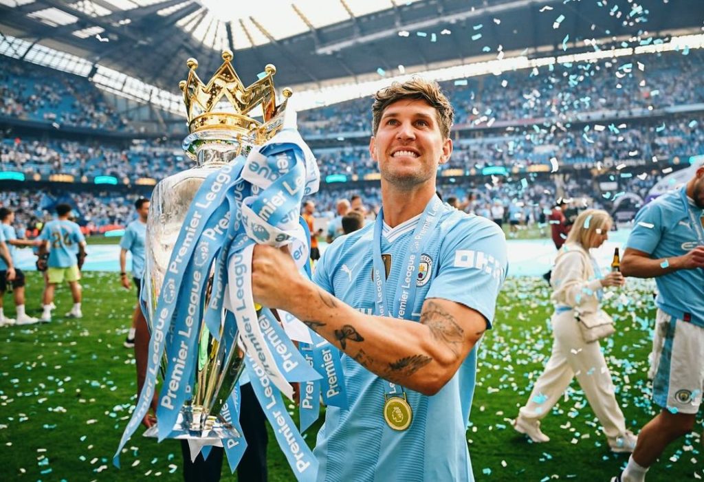 John Stones holding premier league trophy