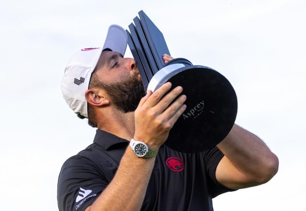 Jon Rahm kissing trophy