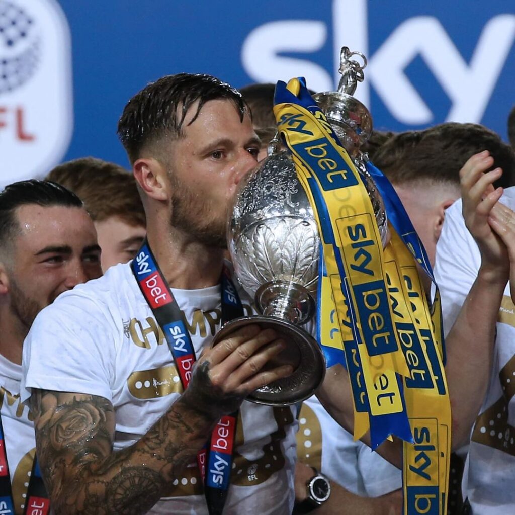 Leads united player kissing a trophy