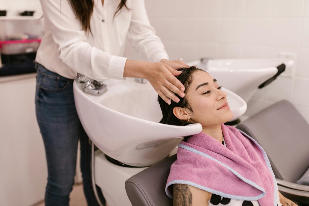 a woman is washing her hair