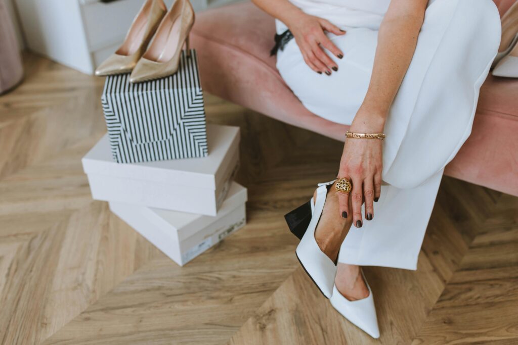 A lady wearing white shoe