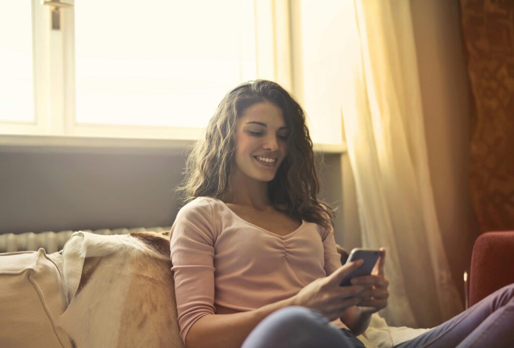 a lady is chating on phone and smiling